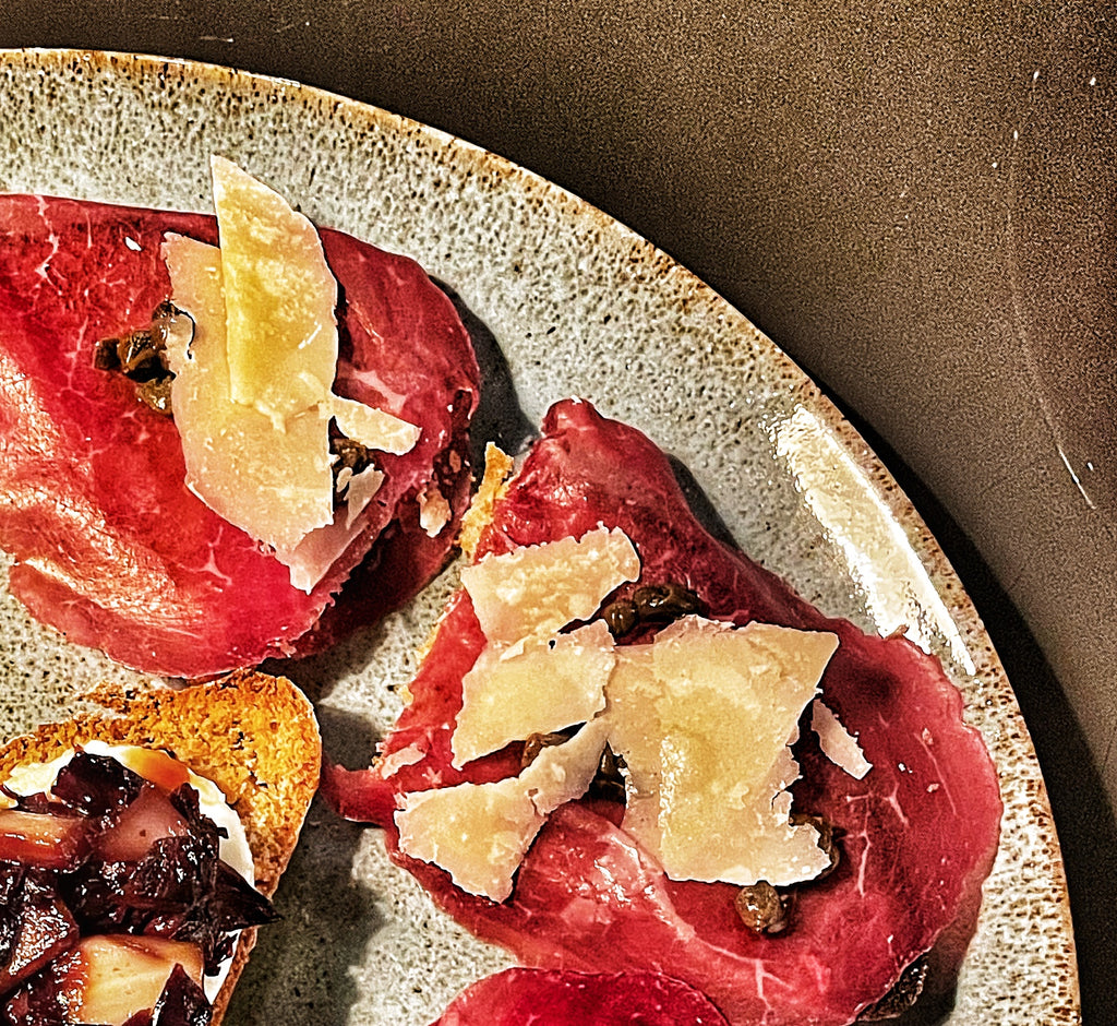 Bresaola crostini with capers, parmigiano reggiano and Tuscan olive oil